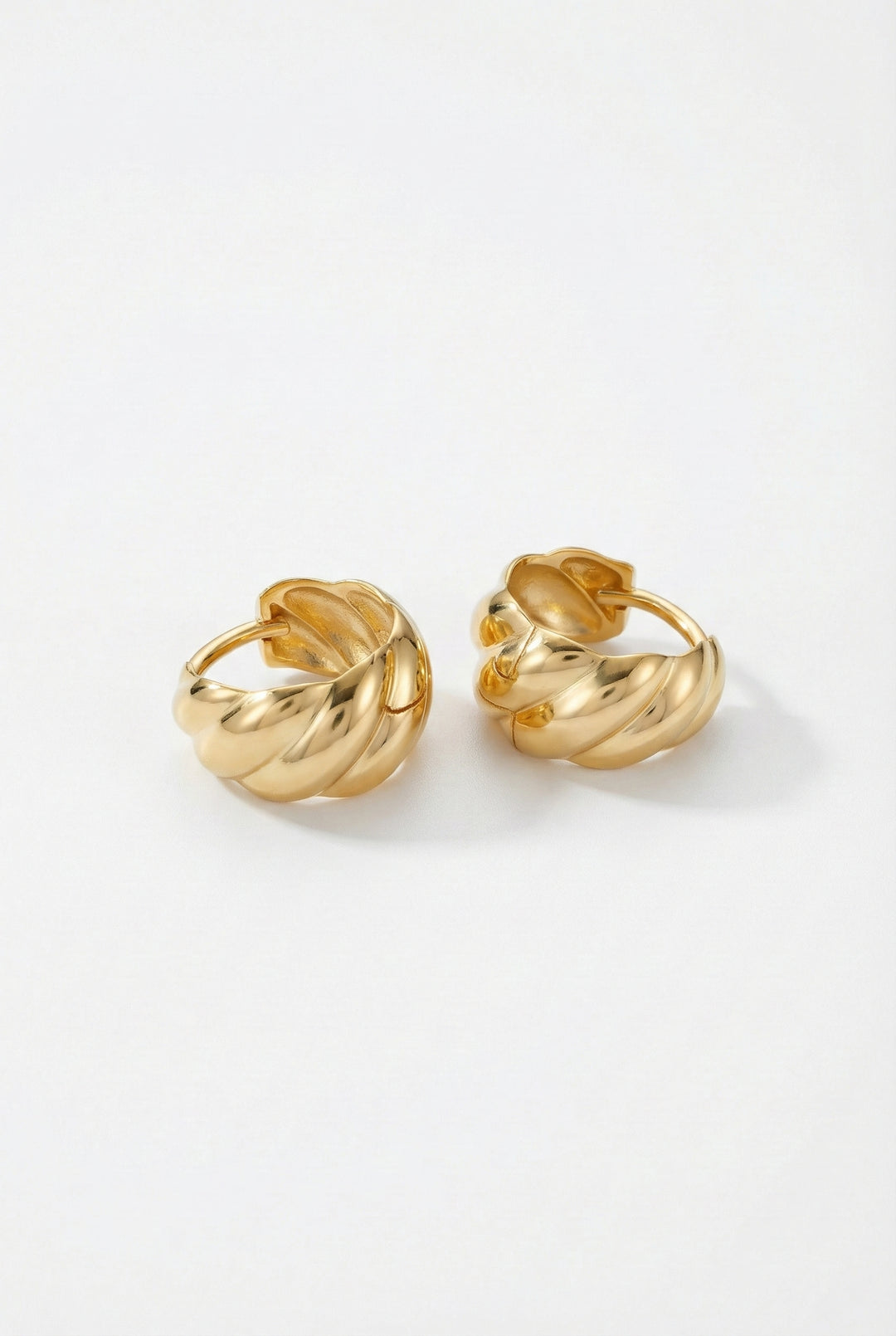 Pair of gold hoop earrings on a white background