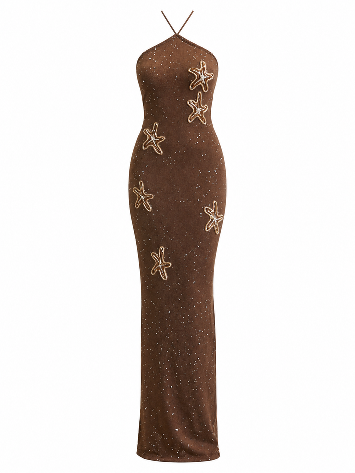 A brown halter-neck maxi dress with a subtle glitter texture and embroidered starfish motifs, shown against a plain white background.